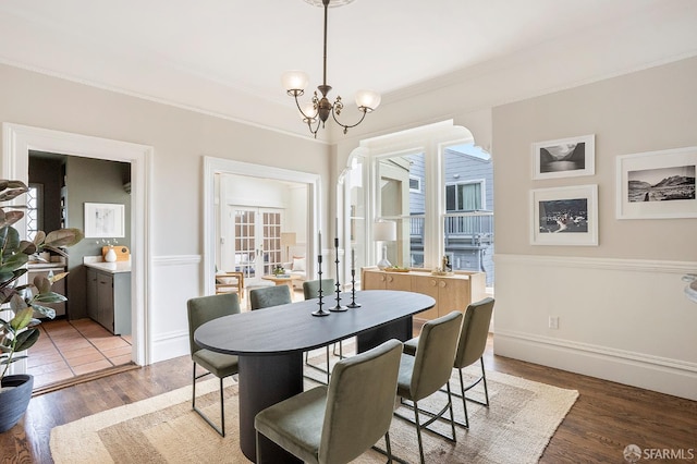 1908 Buchanan St, San Francisco, CA 94115 - dining space with crown molding, a chandelier, and wood finished floors
