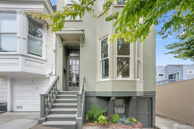 1908 Buchanan St, San Francisco, CA 94115 - property entrance with stucco siding, a garage, and concrete driveway