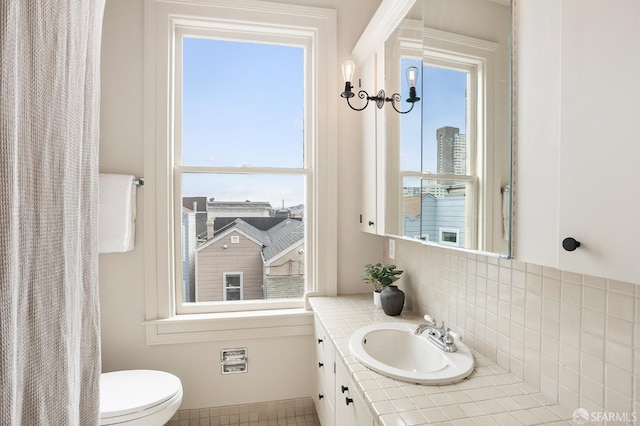 1908 Buchanan St, San Francisco, CA 94115 - bathroom with vanity, plenty of natural light, and decorative backsplash