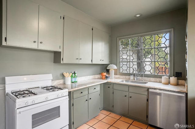 1908 Buchanan St, San Francisco, CA 94115 - kitchen with white gas range oven, stainless steel dishwasher, and light tile patterned floors