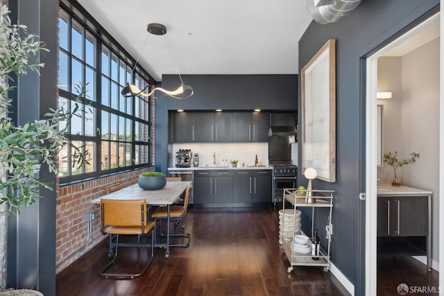 kitchen featuring tasteful backsplash, appliances with stainless steel finishes, dark hardwood / wood-style floors, and sink