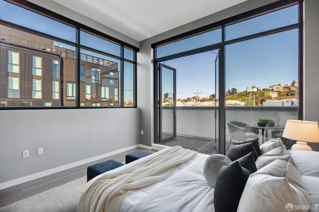 bedroom with hardwood / wood-style flooring and access to outside