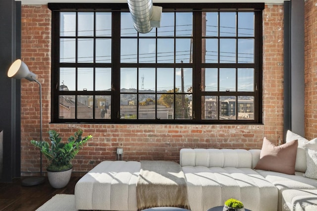 interior space featuring brick wall and hardwood / wood-style floors