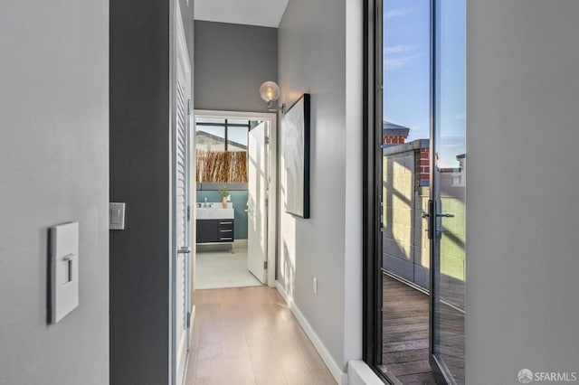 hallway with light hardwood / wood-style floors