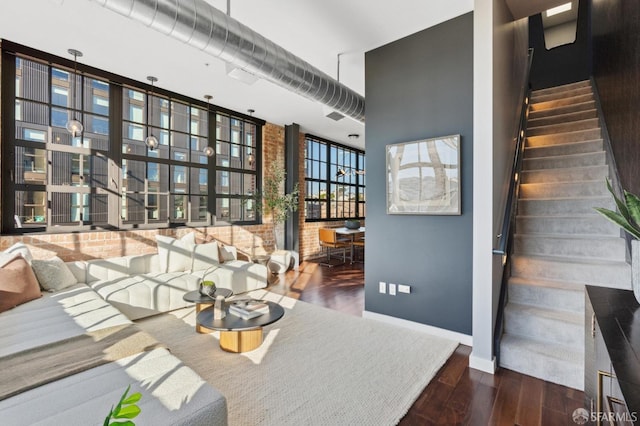 interior space featuring dark hardwood / wood-style flooring, a wall of windows, and a high ceiling