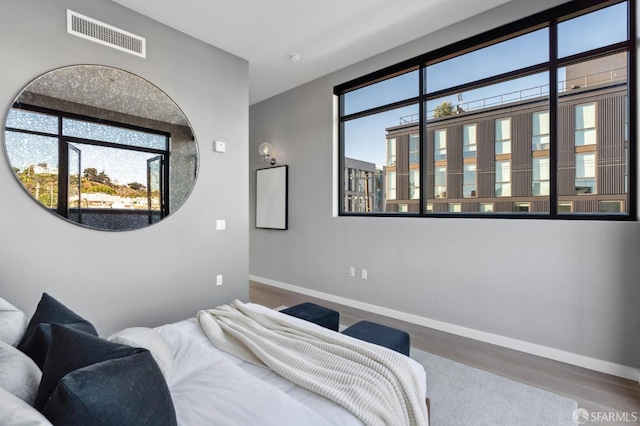 bedroom featuring hardwood / wood-style flooring and multiple windows