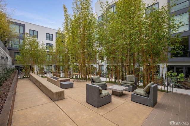 view of property's community featuring an outdoor hangout area and a patio area