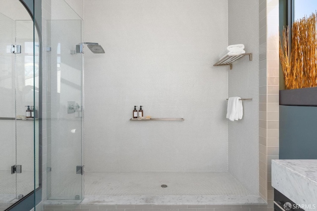 bathroom featuring vanity and an enclosed shower