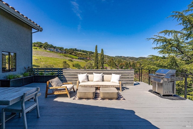 deck with a grill and an outdoor hangout area