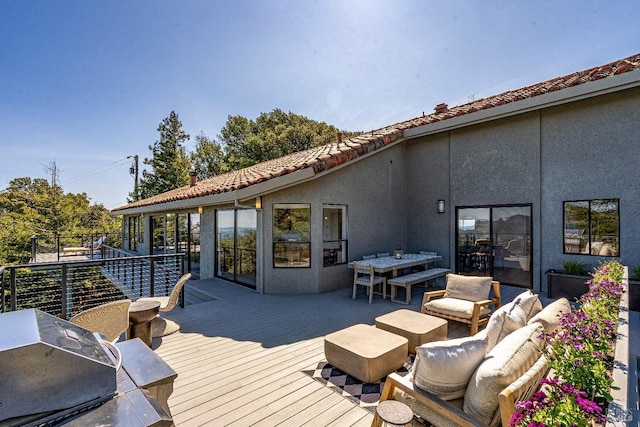 deck featuring outdoor lounge area, outdoor dining space, and a grill