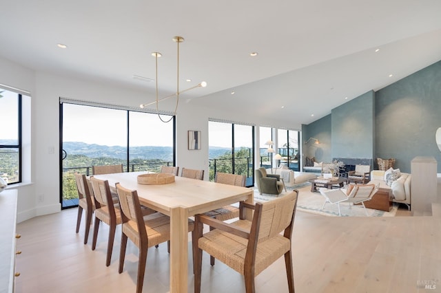 dining area featuring light wood finished floors, a mountain view, and recessed lighting