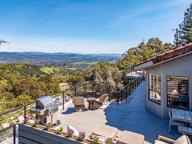 wooden terrace with a mountain view and a grill