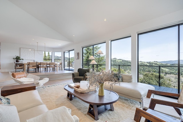 living area featuring high vaulted ceiling and recessed lighting