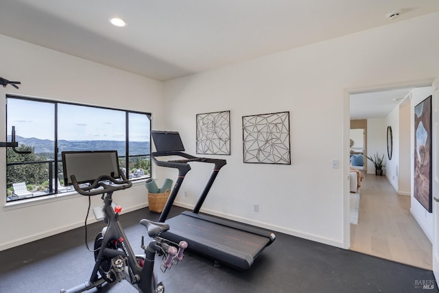 workout room featuring baseboards and recessed lighting