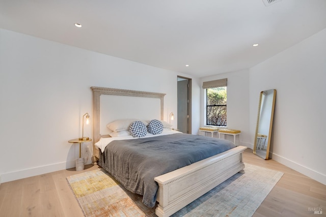 bedroom featuring light wood-type flooring, baseboards, and recessed lighting