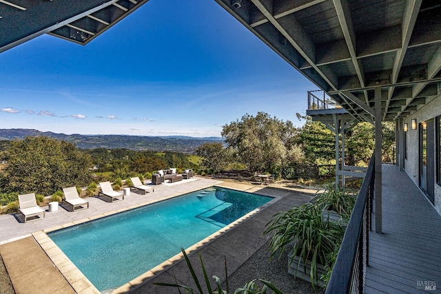 pool featuring a patio, a mountain view, and an outdoor hangout area