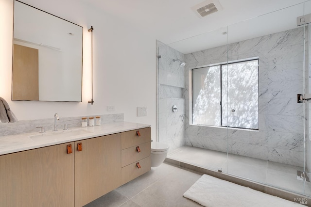 bathroom with a marble finish shower, visible vents, toilet, and vanity