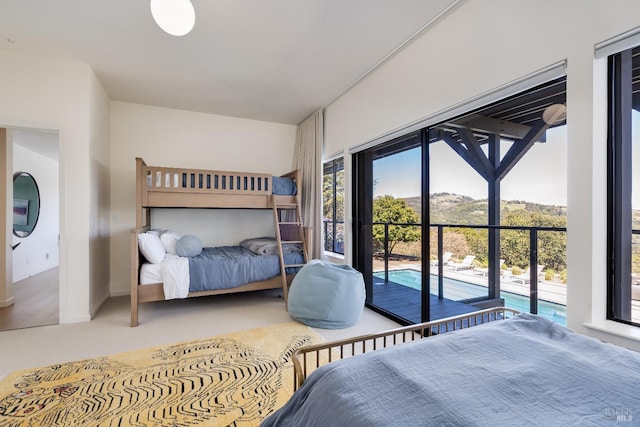 carpeted bedroom with access to exterior
