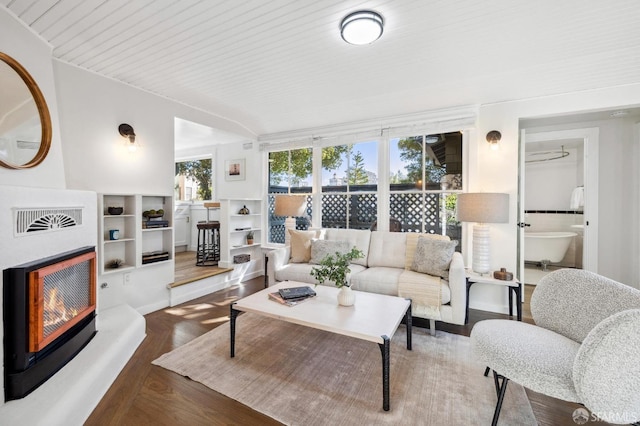 living room with heating unit, wooden ceiling, and hardwood / wood-style flooring