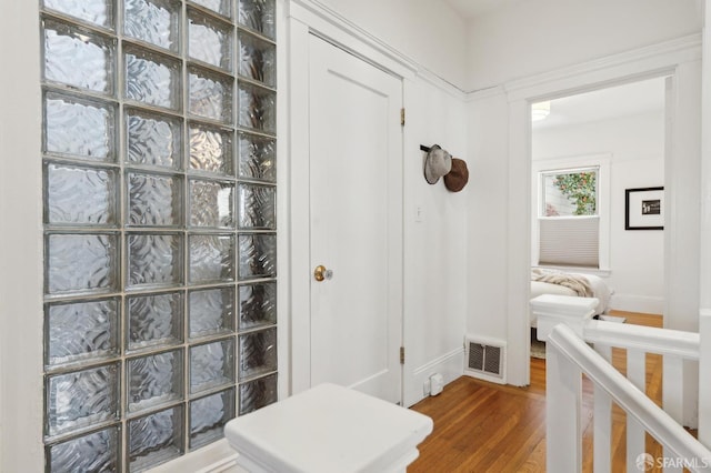 interior space with wood finished floors and baseboards