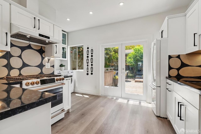kitchen featuring white appliances, under cabinet range hood, recessed lighting, light wood-style flooring, and white cabinets