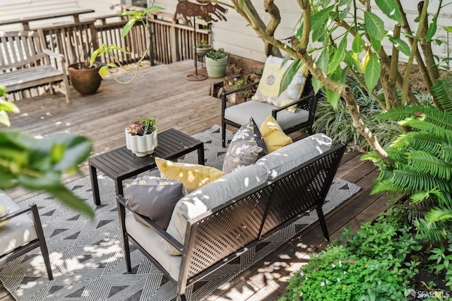 wooden terrace featuring an outdoor living space
