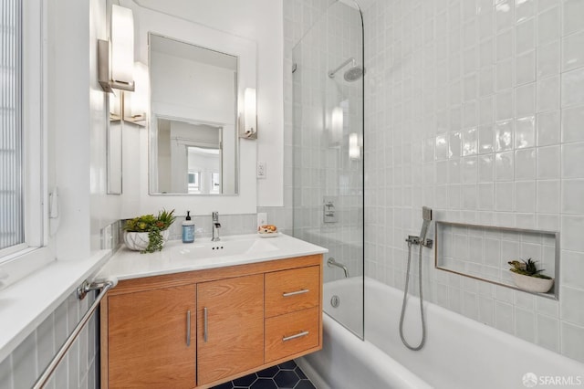 full bath with vanity and tiled shower / bath combo