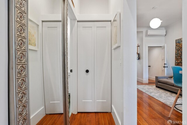 719-721 Shotwell St, San Francisco, CA 94110 - hallway with an AC wall unit and wood finished floors