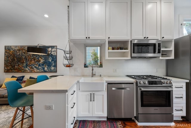 719-721 Shotwell St, San Francisco, CA 94110 - kitchen with appliances with stainless steel finishes, a sink, open shelves, a breakfast bar, and recessed lighting