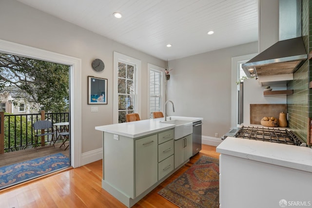 719-721 Shotwell St, San Francisco, CA 94110 - kitchen with wall chimney range hood, a sink, light wood-type flooring, baseboards, and recessed lighting