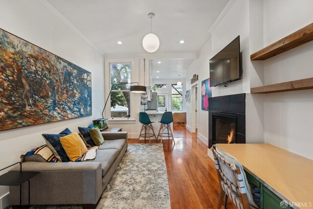 719-721 Shotwell St, San Francisco, CA 94110 - living area featuring wood finished floors, ornamental molding, a glass covered fireplace, recessed lighting, and baseboards