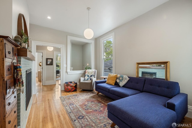 719-721 Shotwell St, San Francisco, CA 94110 - living room featuring a glass covered fireplace, light wood-type flooring, baseboards, and recessed lighting