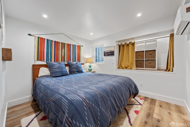 719-721 Shotwell St, San Francisco, CA 94110 - bedroom with a wall mounted AC, wood finished floors, baseboards, and recessed lighting