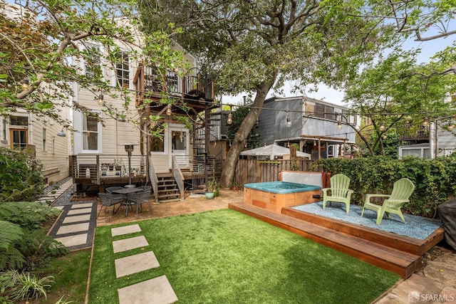 719-721 Shotwell St, San Francisco, CA 94110 - view of yard featuring a hot tub, a wooden deck, and a balcony