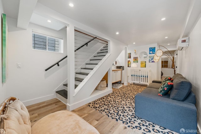 719-721 Shotwell St, San Francisco, CA 94110 - living room featuring wood finished floors, stairway, recessed lighting, an AC wall unit, and baseboards