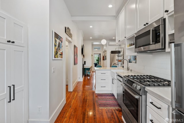 719-721 Shotwell St, San Francisco, CA 94110 - kitchen with appliances with stainless steel finishes, wood finished floors, tasteful backsplash, white cabinets, and recessed lighting