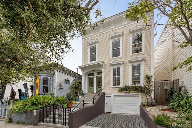 719-721 Shotwell St, San Francisco, CA 94110 - italianate house with a fenced front yard, a garage, driveway, and a gate