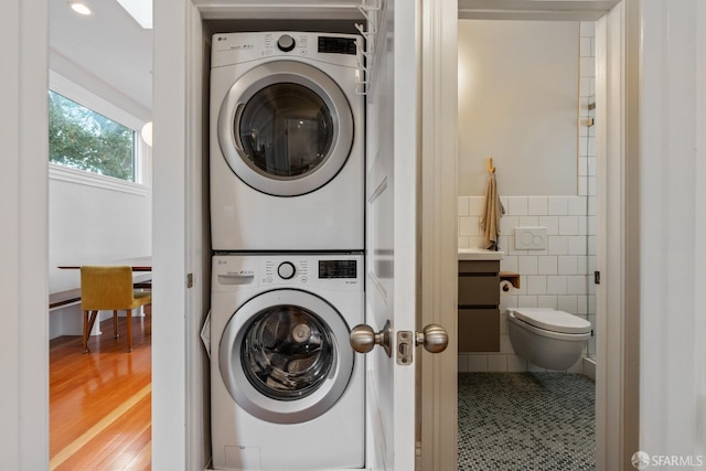 719-721 Shotwell St, San Francisco, CA 94110 - washroom with estacked washer and dryer, tile walls, and wood finished floors