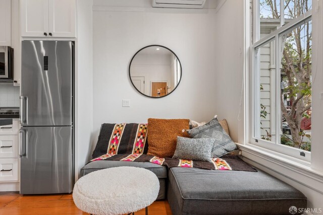 719-721 Shotwell St, San Francisco, CA 94110 - living area featuring wood finished floors and a wall unit AC
