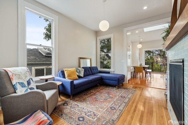 719-721 Shotwell St, San Francisco, CA 94110 - living room with a fireplace, plenty of natural light, light wood-style floors, and recessed lighting