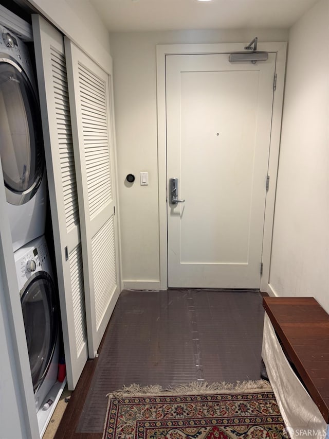 50 Jerrold Ave Unit 215, San Francisco, CA 94124 - washroom featuring stacked washer and clothes dryer, baseboards, and dark wood-style floors
