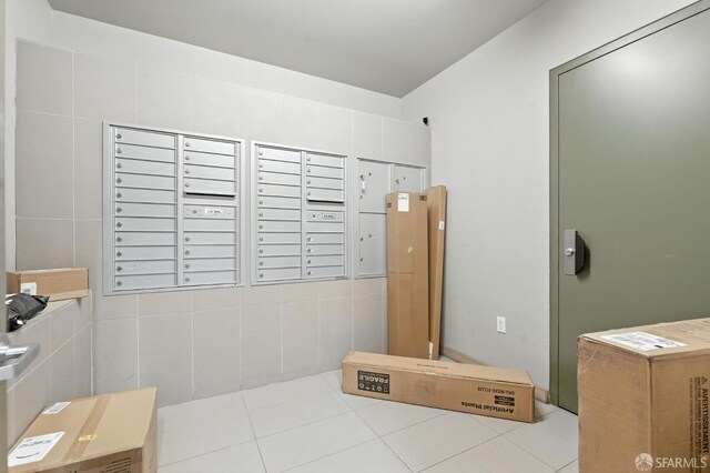 50 Jerrold Ave Unit 215, San Francisco, CA 94124 - bathroom featuring mail area, tile walls, and tile patterned flooring