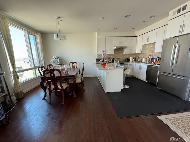 50 Jerrold Ave Unit 215, San Francisco, CA 94124 - kitchen featuring freestanding refrigerator, a peninsula, dishwasher, white cabinets, and recessed lighting