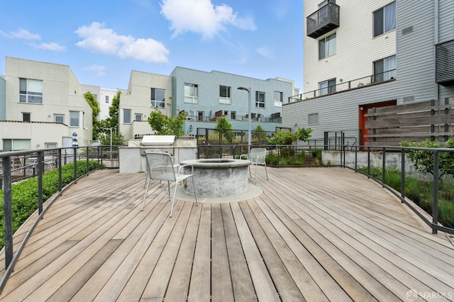 50 Jerrold Ave Unit 215, San Francisco, CA 94124 - wooden deck featuring an outdoor fire pit, a residential view, and exterior kitchen