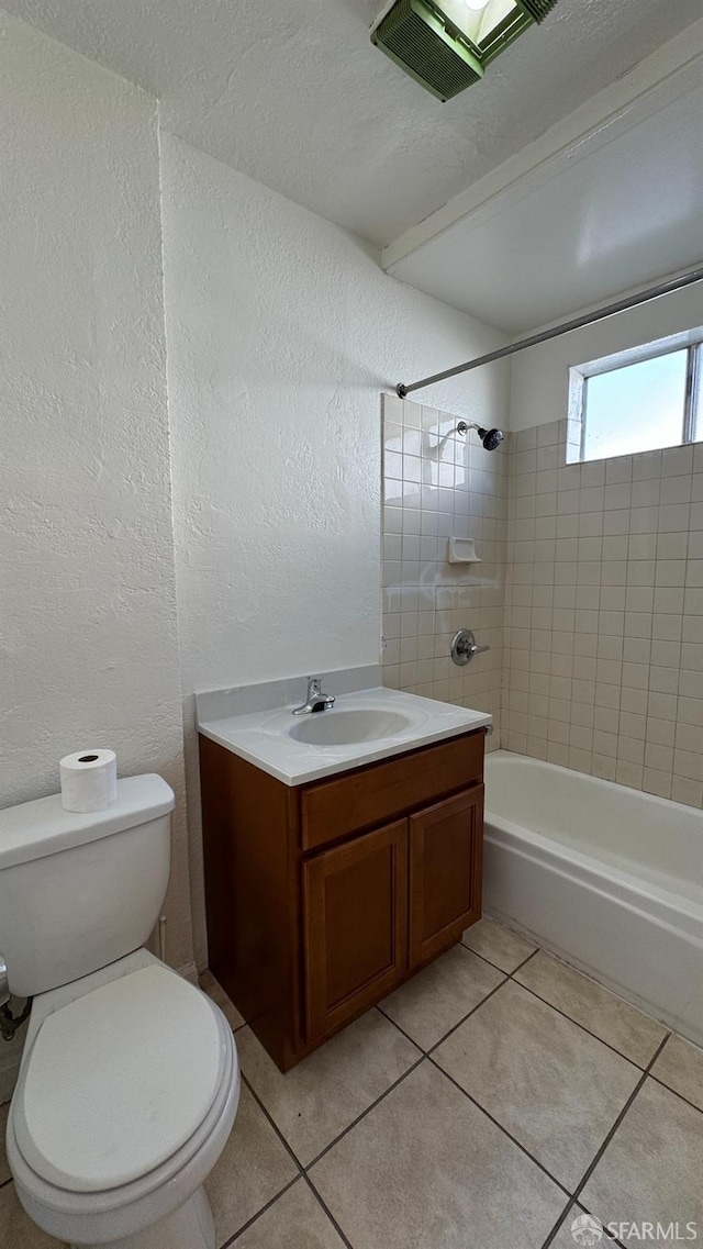 full bathroom with tile patterned floors, toilet, bathing tub / shower combination, vanity, and a textured wall