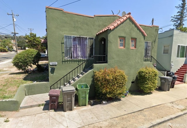 mediterranean / spanish-style house with a tile roof and stucco siding