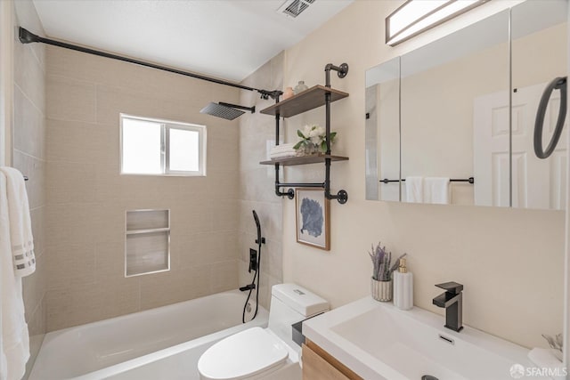 bathroom featuring toilet, vanity, visible vents, and bathing tub / shower combination