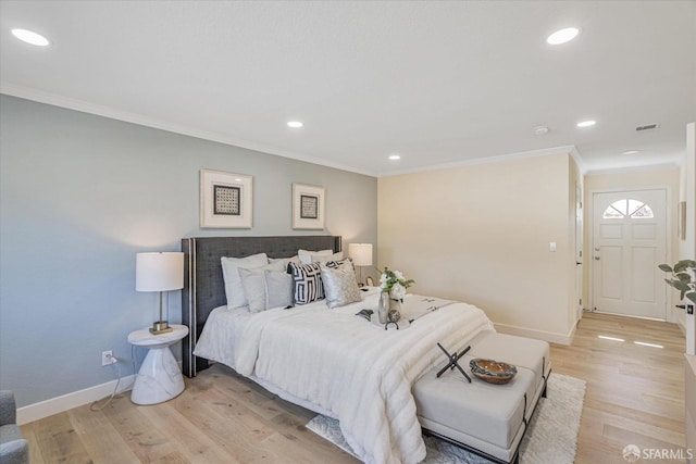 bedroom with baseboards, ornamental molding, recessed lighting, and light wood-style floors