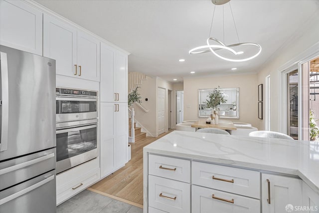 kitchen with light stone counters, recessed lighting, white cabinetry, appliances with stainless steel finishes, and pendant lighting