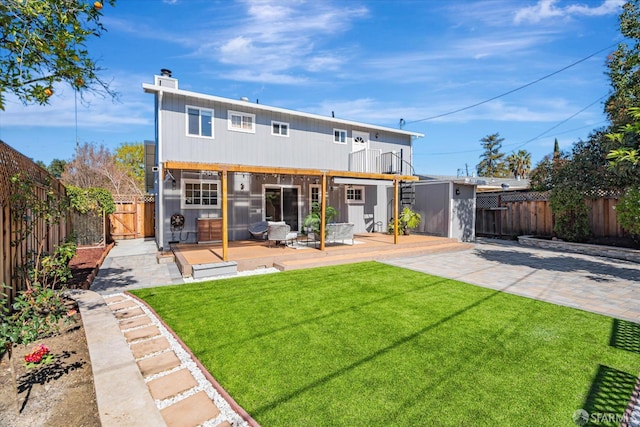 back of property with a patio area, a fenced backyard, a yard, and a wooden deck